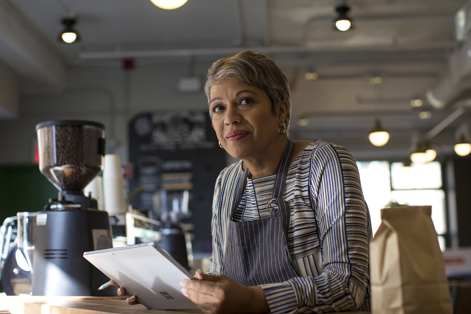 Featured image for Microsoft for Startups blog post titled Helping small businesses grow with conversational AI assistants of a frontline worker achieving in retail workspace using Surface